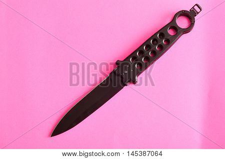 Steel butterfly knife (balisong) displayed on a colorful background