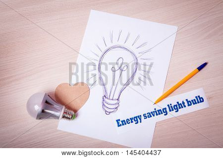 Cartoon energy-saving light bulb painted pen on a sheet of paper. The lamp bulb