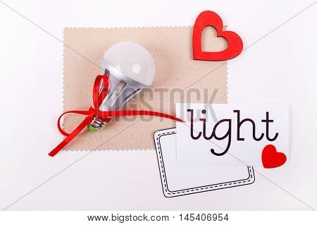 Electric lamp and decorative red heart on a white background