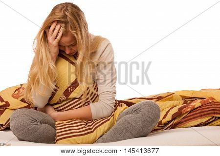 Woman Sitting On Bed Holding Belly Because Of The Pain In Stomac.