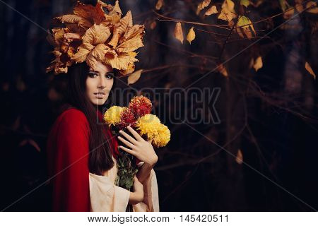 Beautiful Woman With Autumn Leaves Crown Holding Flowers
