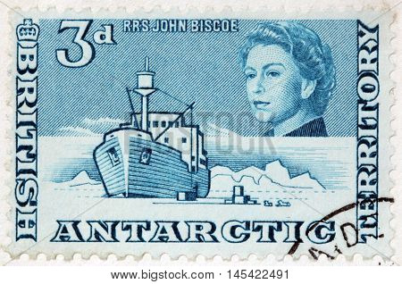 LUGA RUSSIA - JUNE 25 2016: A stamp printed by BRITISH ANTARCTIC TERRITORY shows image portrait of Queen Elizabeth II against polar landscape with famous RRS John Biscoe circa 2013
