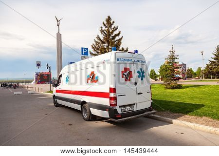 SAMARA RUSSIA - MAY 8 2016: Ambulance car parked up in the street. Text in russian: "Emergency Medicine"