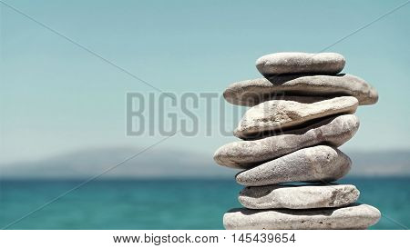 Stack of Sea Pebbles on a Calm Sea Background