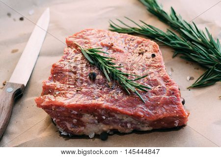 Cooking beef steak with rosemary and pepper