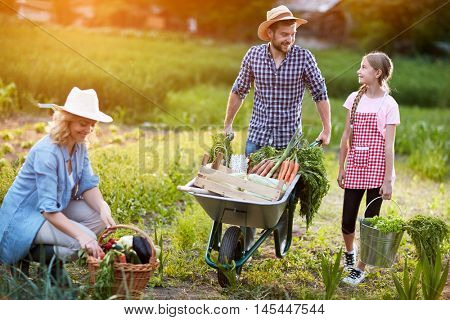 Diligent farmers family in garden