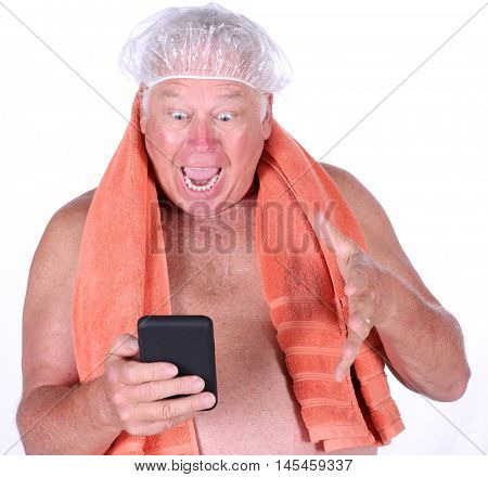 A man reacts to a photo he sees on his cell phone as he exits the shower. isolated on white. room for text. Shutterstock model released