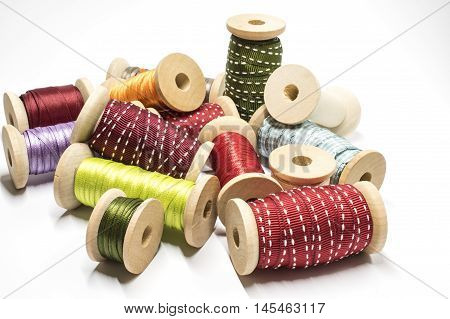 A heap of several ribbons on wooden spools