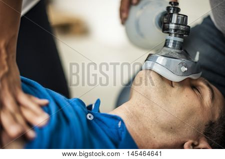 operators assisting an unconscious man after heart attack