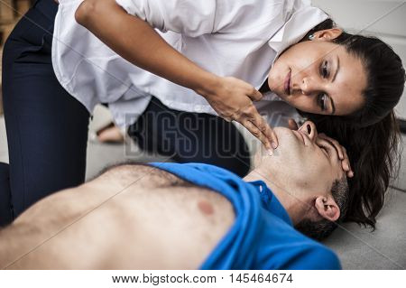 girl assisting an unconscious man after fatal accident