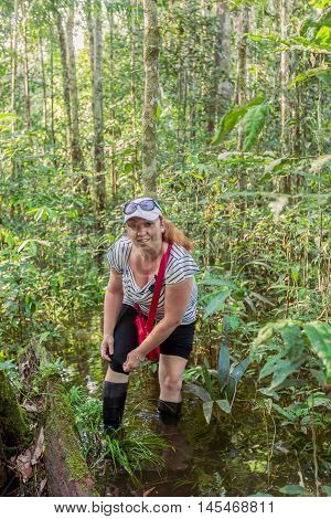 European Blonde Woman Exploring The Jungle swamp In Cuyabeno National Park South America