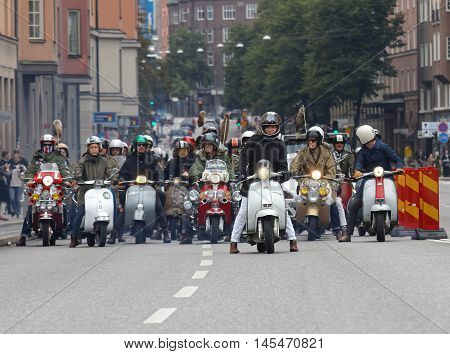 STOCKHOLM SWEDEN - SEPT 03 2016: Large group of mods on old fashioned vespas at the Mods vs Rockers event at the Saint Eriks bridge Stockholm Sweden September 03 2016