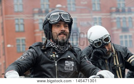 STOCKHOLM SWEDEN - SEPT 03 2016: Closeup of two bikers wearing leather clothes at the Mods vs Rockers event at the St:Eriks bridge Stockholm Sweden September 02 2016