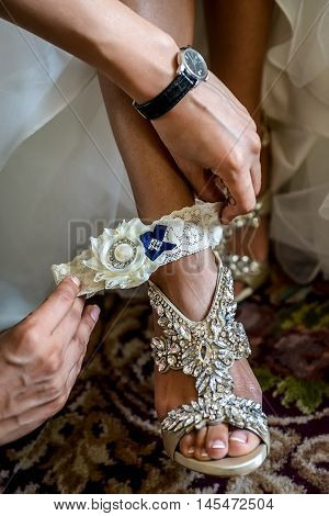 Bride Putting On Wedding Garter