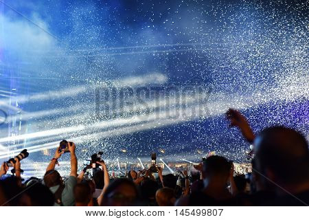Throwing Confetti Over Crowd At Live Concert