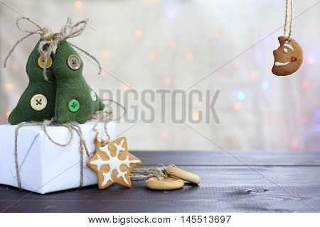 holiday table with gift and delicious gingerbread on the background of Christmas lights / preparation for the Christmas meeting