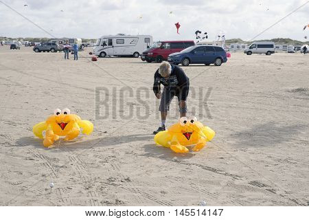 LAKOLK DENMARK - SEPTEMBER 3 2016: Colorful yellow crab kites on the big beach on Lakolk Romo. International Kite Festival for the 27th time. September 3 2016.