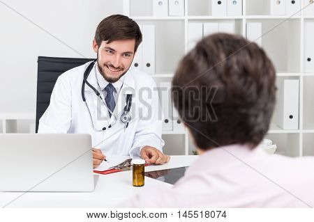 Smiling Doctor With Beard Talking To His Patient