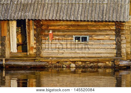 Woodet traditional bathowue on lake in sundown rays