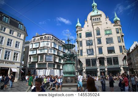 Copenhagen Denmark - August 15 2016: Many people near fountain Stork on Amagertorv square at the city centre. Copenhagen is the capital and most populated city of Denmark.