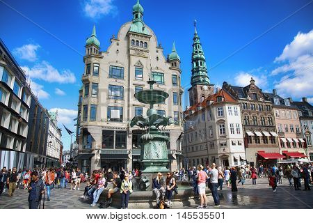 Copenhagen Denmark - August 15 2016: Many people near fountain Stork on Amagertorv square at the city centre. Copenhagen is the capital and most populated city of Denmark.
