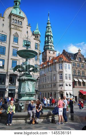 Copenhagen Denmark - August 15 2016: Many people near fountain Stork on Amagertorv square at the city centre. Copenhagen is the capital and most populated city of Denmark.