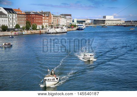 Copenhagen Denmark - August 15 2016: View on people with boats and The Copenhagen Opera House from Knippelsbro bascule bridge in Copenhagen Denmark