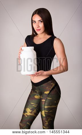 Athletic girl and sports nutrition. Sport concept.