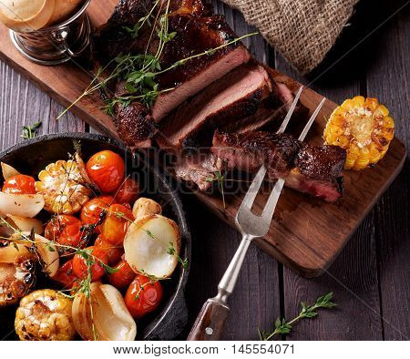 Grilled Steak Sliced On A Cutting Board.