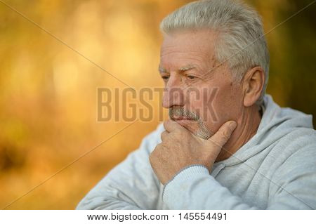 Portrait of a senior man thinking about something outdoor