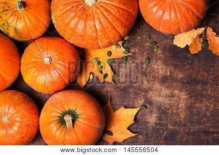 Autumn Pumpkin Thanksgiving Background - orange pumpkins over wooden table