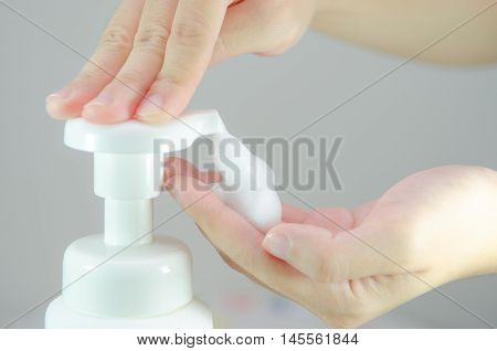 Putting whip foam soap on the hand.