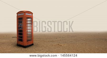 Lone phone booth standing in the desert.