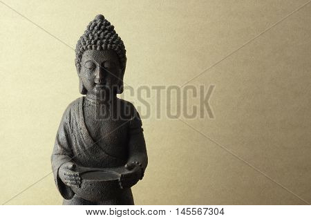 Buddha statue on a beige background close up
