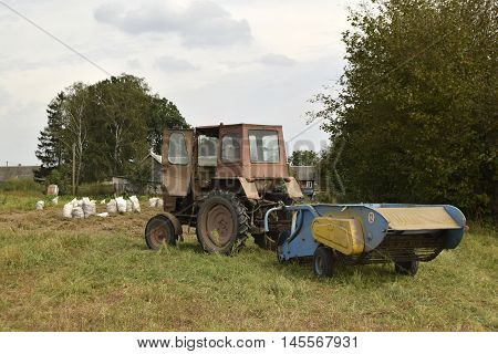 Agricultural field. The crop is reaped. Work is performed by means of the tractor.