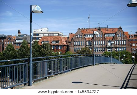 A footbridge over the Weser River with views of the old town and waterfront.