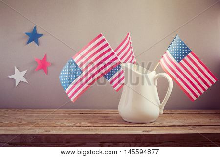 USA independence day celebration. USA flags in jug on wooden table