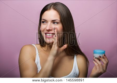 Pretty Woman With A Skin Care Product