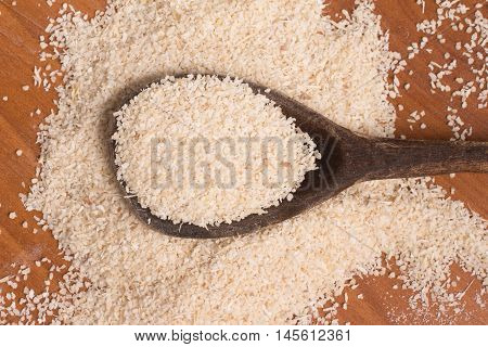 Farinha de Mandioca. Manioc. Cassava flour over a wooden table