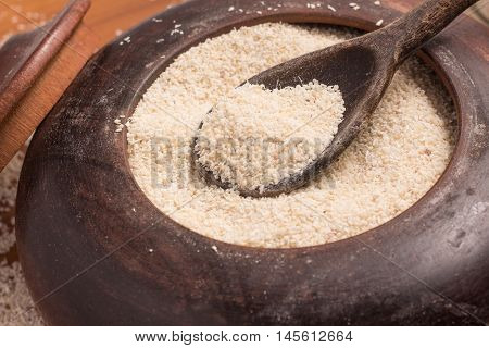Farinha de Mandioca. Manioc. Cassava flour over a wooden table