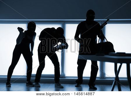 Armed thieves entering a house