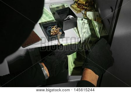 Thieves stealing money from safe