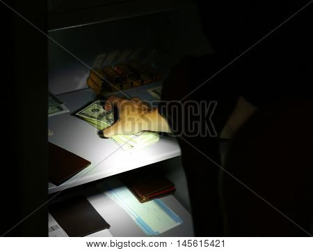 Thieves stealing money from safe