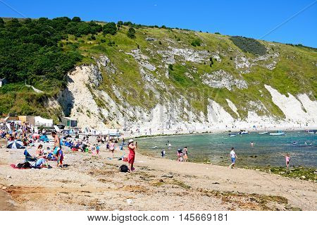 LULWORTH COVE, UNITED KINGDOM - JULY 19, 2016 - View of the beach and cove with holidaymakers enjoying the setting Lulworth Cove Dorset England UK Western Europe, July 19, 2016.