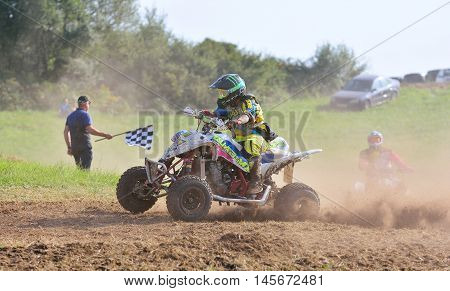 Unidentified Racer Rides A Quad Motorbike.