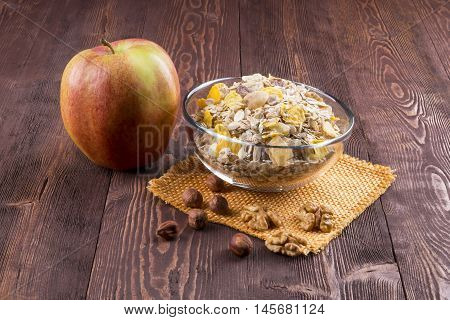 bowl of muesli apple nuts flakes candied for a nutritious breakfast with a low glycemic index ensuring plenty of energy for the day.