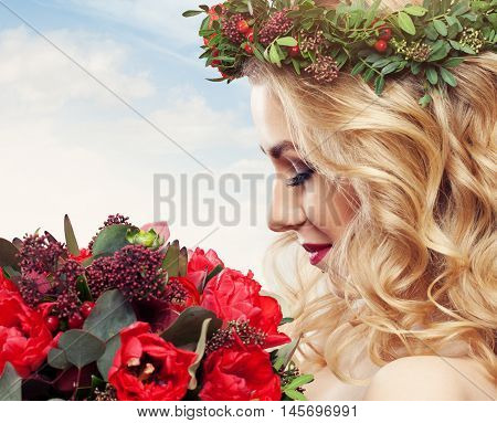 Beautiful Woman with Flowers on sky background