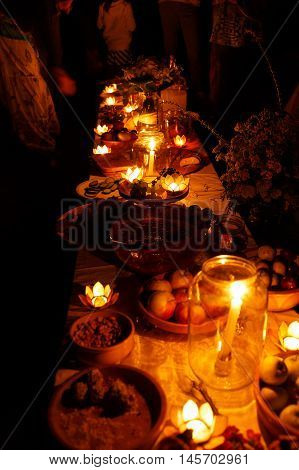 nocturnal wedding feast held in nature with enchanting lotus shape cande holders
