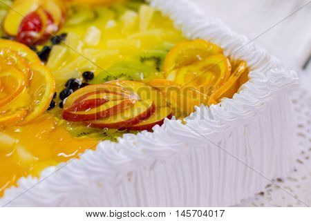 Dessert with fruits and cream. Pieces of apple in jelly. Delicious treat for party guests. Tasty cake from pastry shop.
