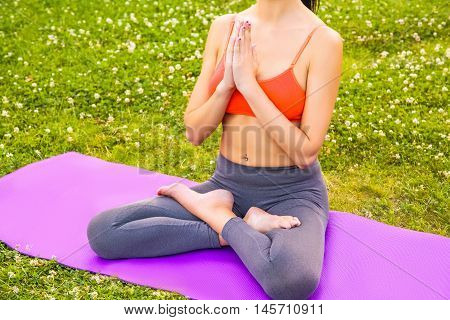 Young Woman Practicing Yoga In The Park.